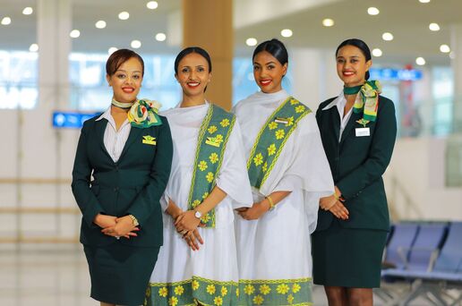 Ethiopian Airlines female crew in elegant uniforms celebrating Women’s Day with pride at the airport.
